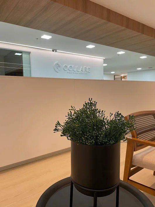Detalhe da recepção Oculare Medical Center — planta e logotipo
